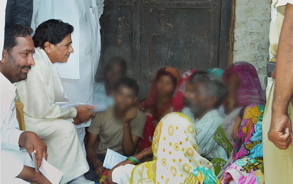 BSP supremo Mayawati interacts with the family members of two sisters who were gang raped and hanged from a tree at Katra Shahadatganj village, in Badaun district.