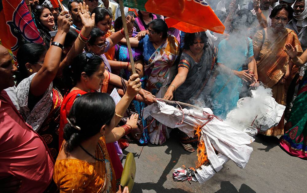 Bharatiya Janata Party (BJP) women workers raise slogans and burn an effigy of Akhilesh Yadav, chief minister of the northern Indian state of Uttar Pradesh, during a protest against the gang rape of two teenage girls, in Allahabad.