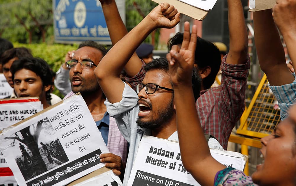 Members of Jawaharlal Nehru University Students Union shout slogans as they participate in a protest against a gang rape of two teenage girls in Katra village, outside the Uttar Pradesh state house, in New Delhi.