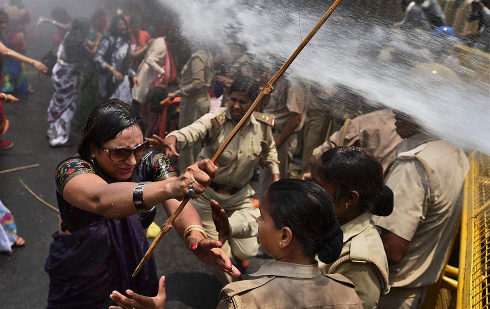 A woman, one among the protestors demonstrating outside the office of Uttar Pradesh state chief minister Akhilesh Yadav, demanding that he crack down on an increasing number of rape and other attacks on women and girls, scuffles with police in Lucknow.