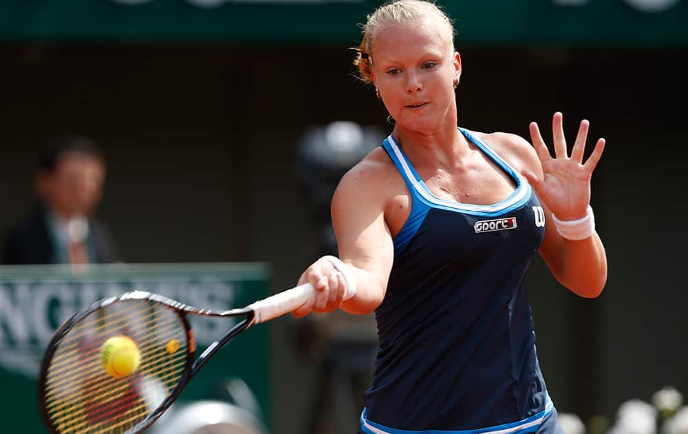 Netherlands` Kiki Bertens retuns the ball to Germany`s Andrea Petkovic during their fourth round match of the French Open tennis tournament at the Roland Garros stadium, in Paris.