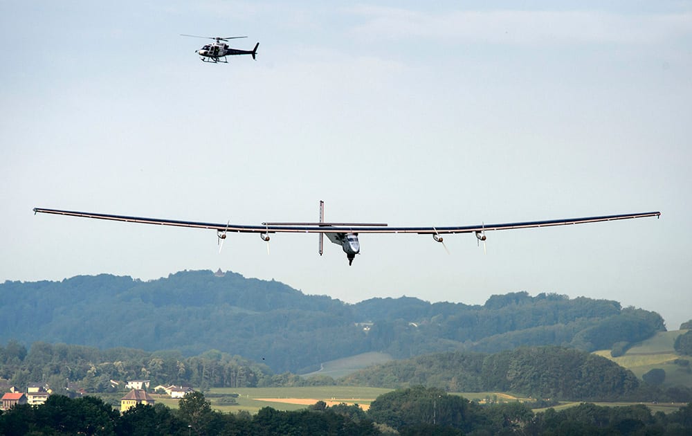 German test pilot Markus Scherdel lands the solar-powered Solar Impulse 2 aircraft after its first flight in Payerne, Switzerland. The aircraft, which was unveiled on April 9, 2014 weighs 2.4 tons with a wingspan of 72 meter and more than 17,000 solar cells. The attempt to fly around the world in stages using only solar energy will be made in 2015.