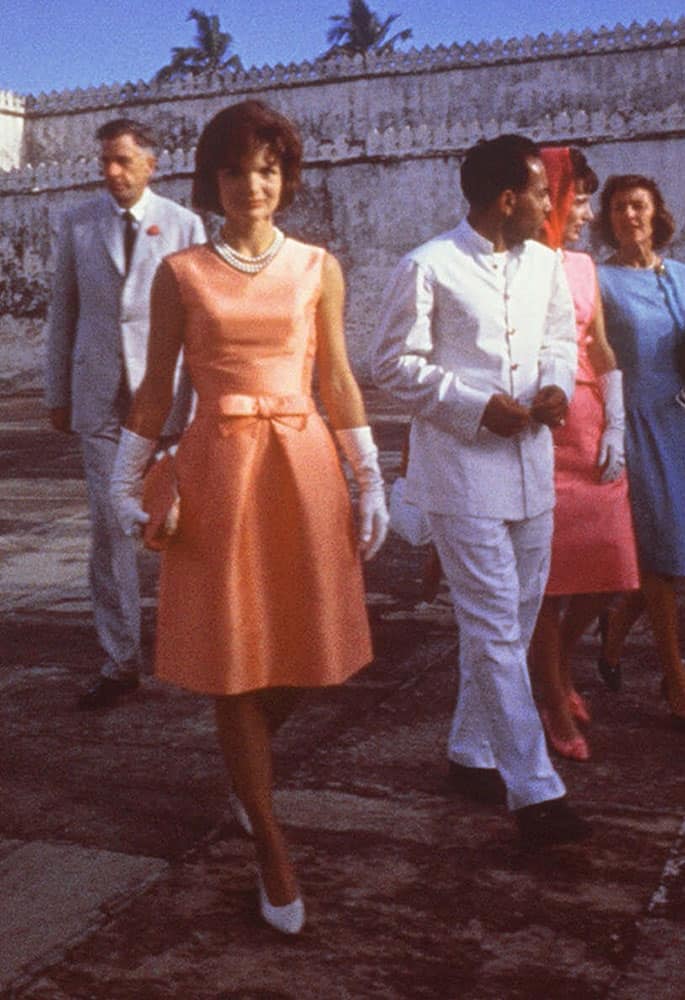 This handout photo provided by the John F. Kennedy Library and Museum, taken March 17, 1962, shows first lady Jacqueline Kennedy, center, touring the Palace of the Maharajah in Udaipur, India, wearing an apricot silk ziberline dress by Oleg Cassini during a state visit to Udaipur, India.