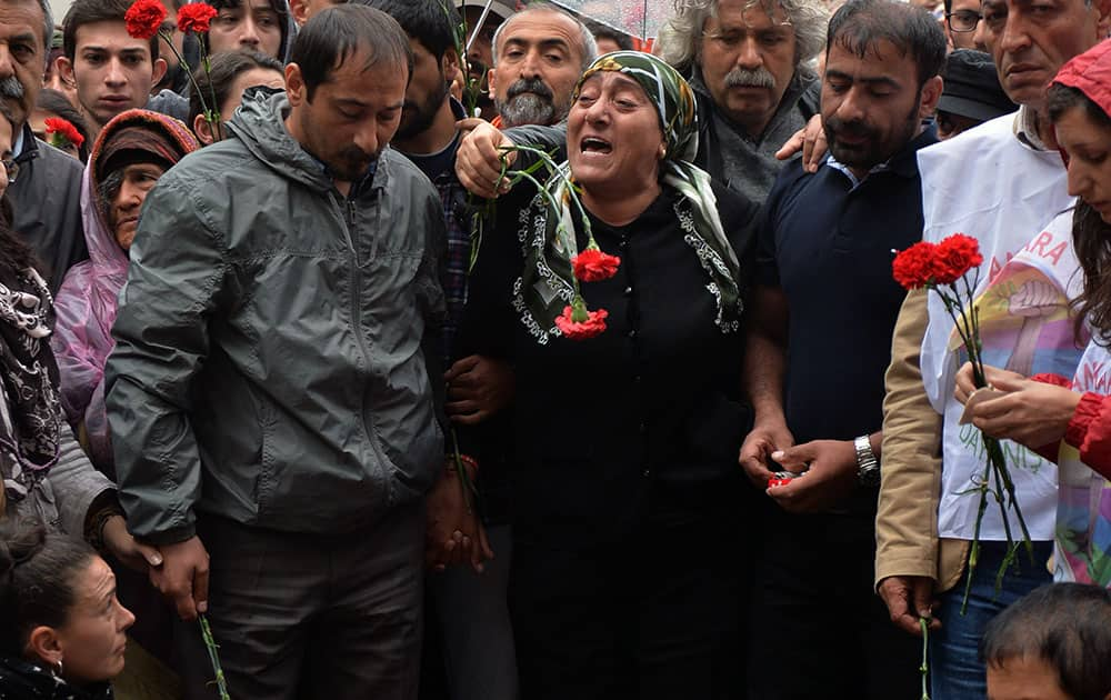 Family members and mother Safi Sarisuluk, center, arrive to lay carnations on the site where Ethem Sarisuluk, a 26-year-old man, was shot down allegedly by a police officer, on the first anniversary of last year`s protests in Ankara, Turkey.