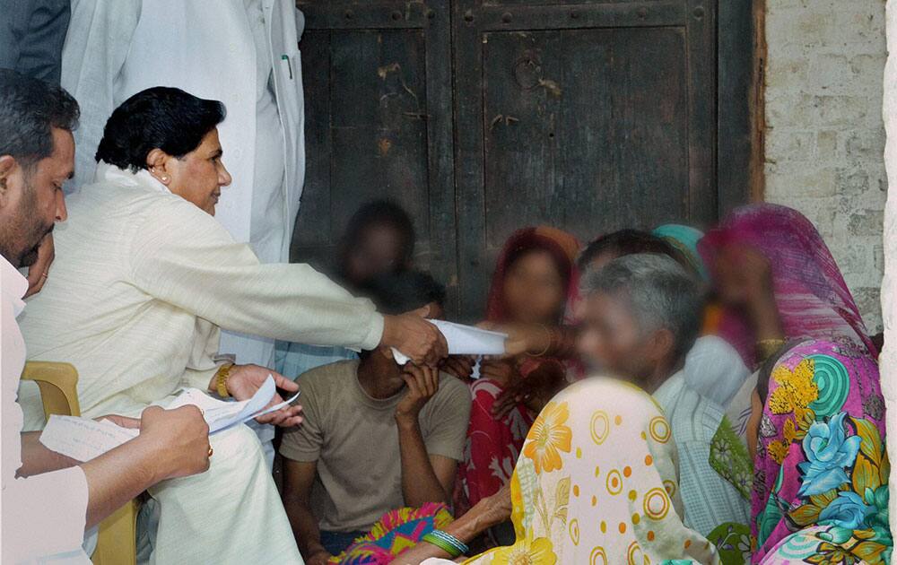 BSP supremo Mayawati interacts with the family members of two sisters who were gang raped and hanged from a tree at Katra Shahadatganj village, in Badaun district.