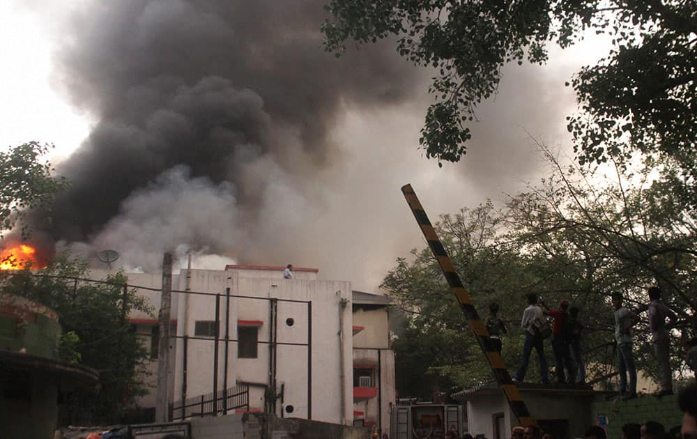 Smoke comes out of a railways building near Shanker Market in New Delhi.