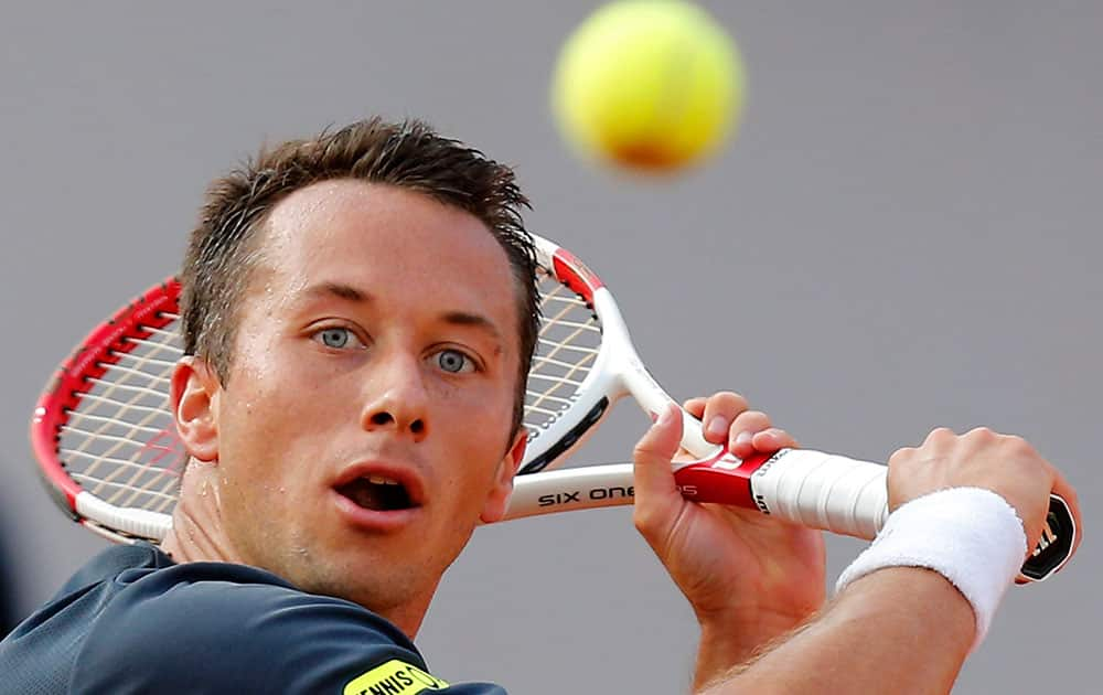 Germany`s Philipp Kohlschreiber returns in the fifth set during the third round match of the French Open tennis tournament against Britain`s Andy Murray at the Roland Garros stadium, in Paris, France.