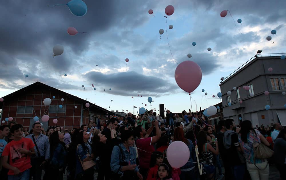 Hundreds of balloons with wishes attached are released by people during a sunset vigil in northern Greek city of Thessaloniki.