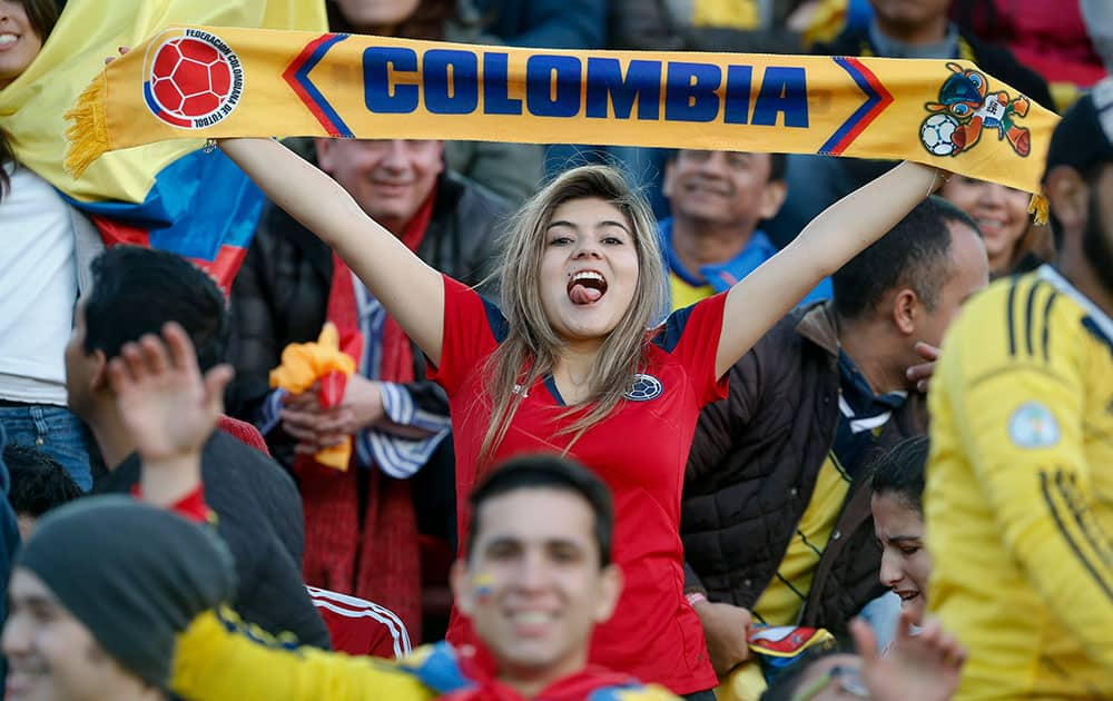 A Colombian fan cheers for her team before an international friendly soccer match against Senegal in Buenos Aires, Argentina.