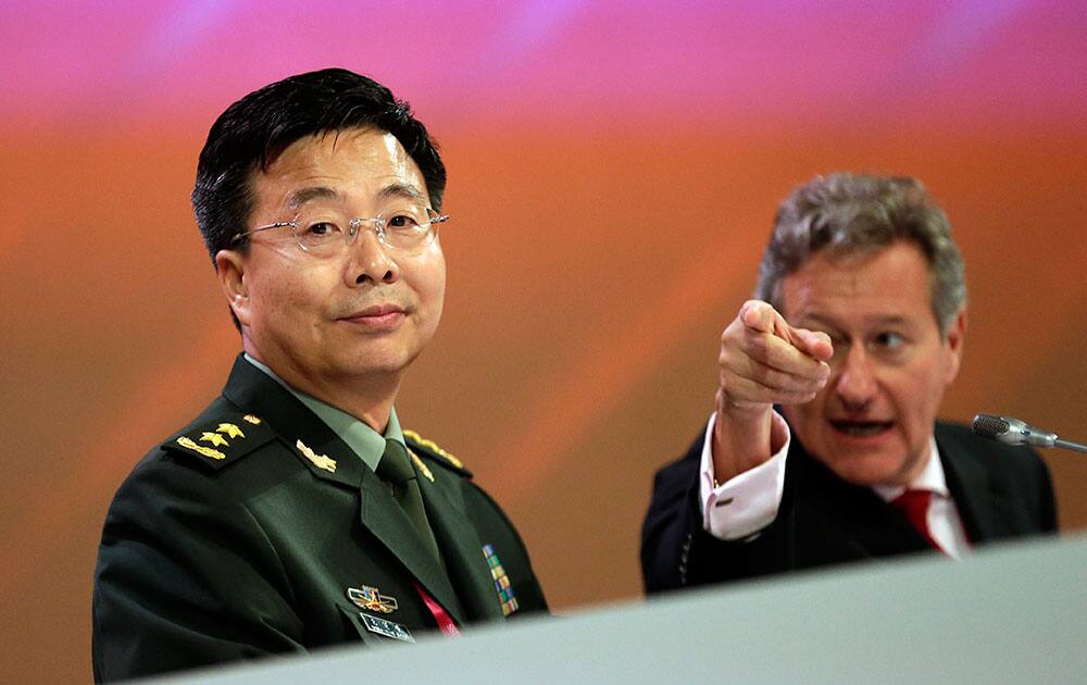 Director-General and Chief Executive of International Institute for Stategic Studies (IISS), Dr. John Chipman, right, directs the attention of China`s Deputy Chief, General Staff Department, People`s Liberation Army of China, Wang Guangzhong, left, to the podium before he delivers his speech on `Major Power Perspectives on Peace and Security in the Asia-Pacific` in Singapore during the Asia Security Summit, known as the Shangri-La Dialogue.