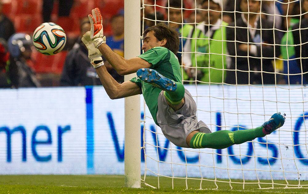 River Plate goalkkeper Marcelo Banodero blocks a penalty shot by Boca Juniors´ Federico Bravo during a friendly soccer match in Mexico City.