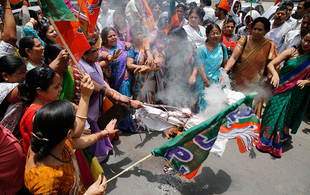 Bharatiya Janata Party (BJP) women workers raise slogans and burn an effigy of Akhilesh Yadav, chief minister of the northern Indian state of Uttar Pradesh, during a protest against the gang rape of two teenage girls, in Allahabad.