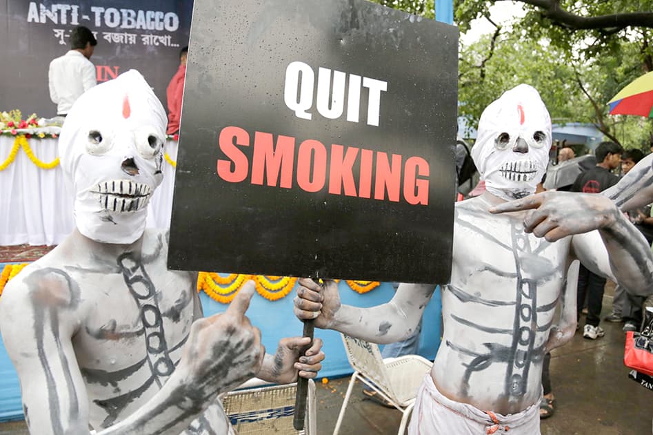 Activists dressed as skeletons participate in an awareness campaign on World No Tobacco Day in Kolkata. Banner reads `smoking is the other name for death.`