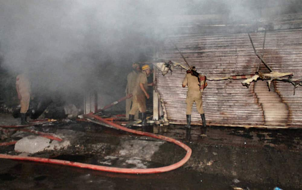 Fire personnel dousing a major fire that broke out in a hotel in Jammu.