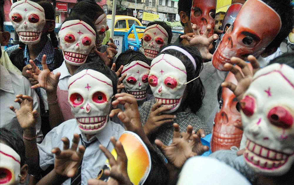 Children wear masks at an awareness campaign on World No Tobacco Day in North Kolkata.