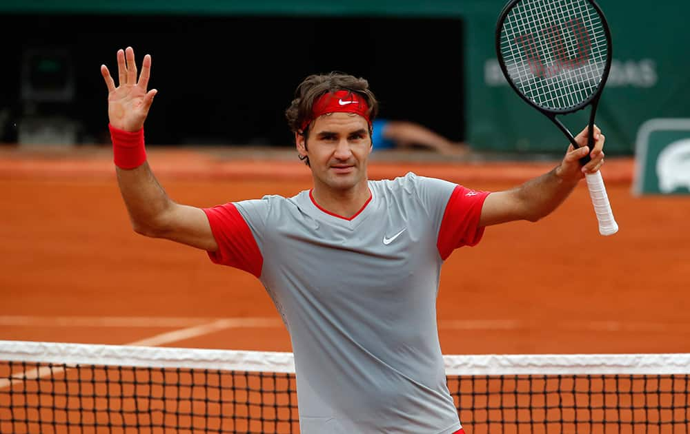 Switzerland`s Roger Federer celebrates winning the third round match of the French Open tennis tournament against Russia`s Dmitry Tursunov at the Roland Garros stadium, in Paris. Federer won in four sets 7-5, 6-7, 6-2, 6-4.