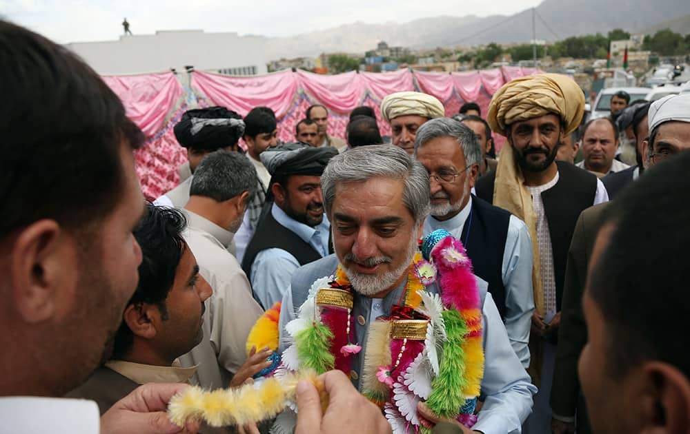 Afghan presidential candidate Abdullah Abdullah, center, greets his supporters during a campaign rally in Kabul, Afghanistan. The second round of Afghanistan`s presidential election will take place on June 14, 2014.