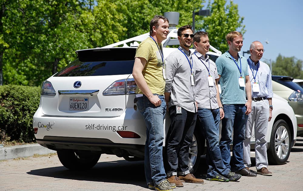 Google team members pose by a Google self-driving car at the Computer History Museum in Mountain View, Calif. From left is project direct Chris Urmson, Brian Torcellini, Dimitri Dolgov, Andrew Chatham and Ron Medford, the director of safety for the project. Four years ago, the Google team developing cars which can drive themselves became convinced that, sooner than later, the technology would be ready for the masses. There was just one problem: Driverless cars almost certainly were illegal.