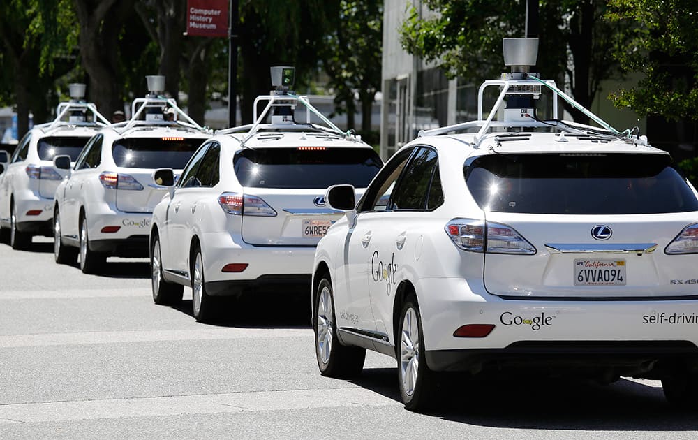 A row of Google self-driving cars are shown outside the Computer History Museum in Mountain View, Calif. Four years ago, the Google team developing cars which can drive themselves became convinced that, sooner than later, the technology would be ready for the masses. There was just one problem: Driverless cars almost certainly were illegal.