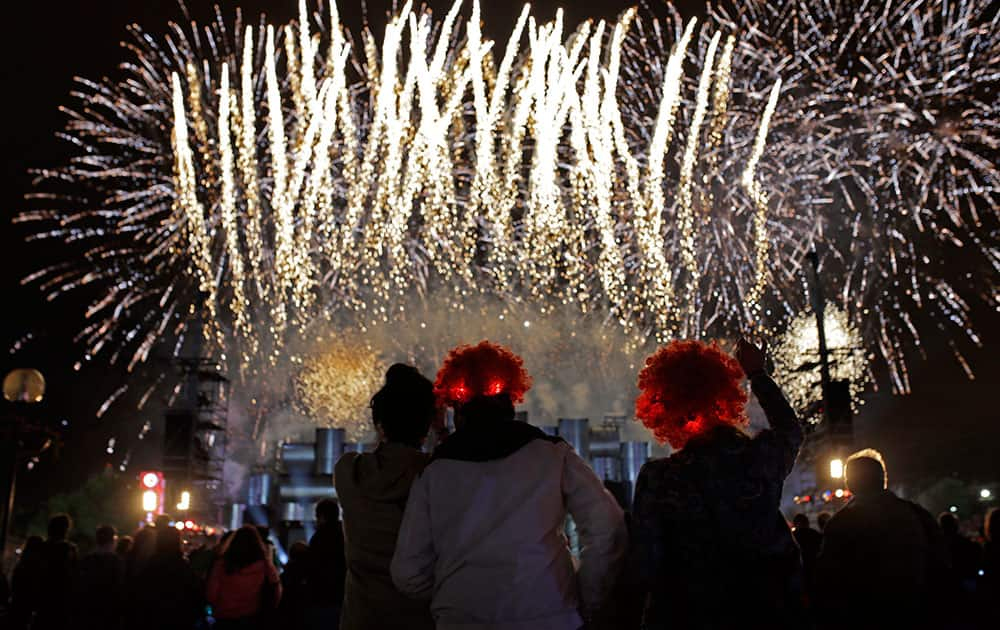 Goers watch fireworks as they wait for a concert during the Rock in Rio music festival, in Lisbon.