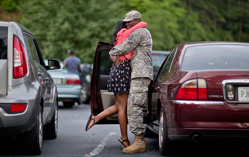 Sgt. Justin Sheffield, right, embraces his wife, Brittany Sheffield, both 25 of Cartersville, Ga., as he says goodbye on the eve his unit, the Georgia National Guard 876th Vertical EN Company, deploys to Afghanistan.