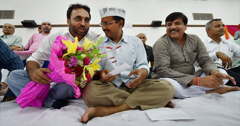 AAP convener Arvind Kejriwal greets party`s newly elected MP Bhagwant Mann during the party workers meeting in New Delhi.