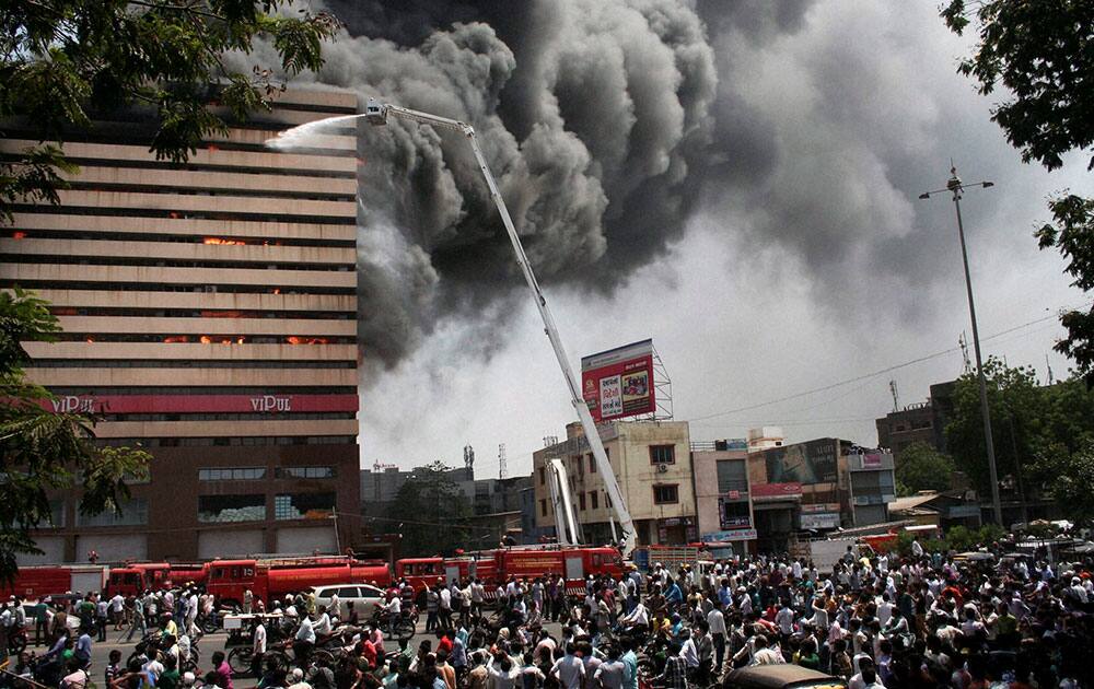 Smoke gushes out of the Orchid Vipul Multistorey Building in Surat.