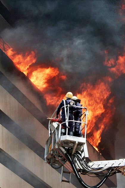 Fire fighters try to control fire in the Orchid Vipul multi storey Building in Surat.