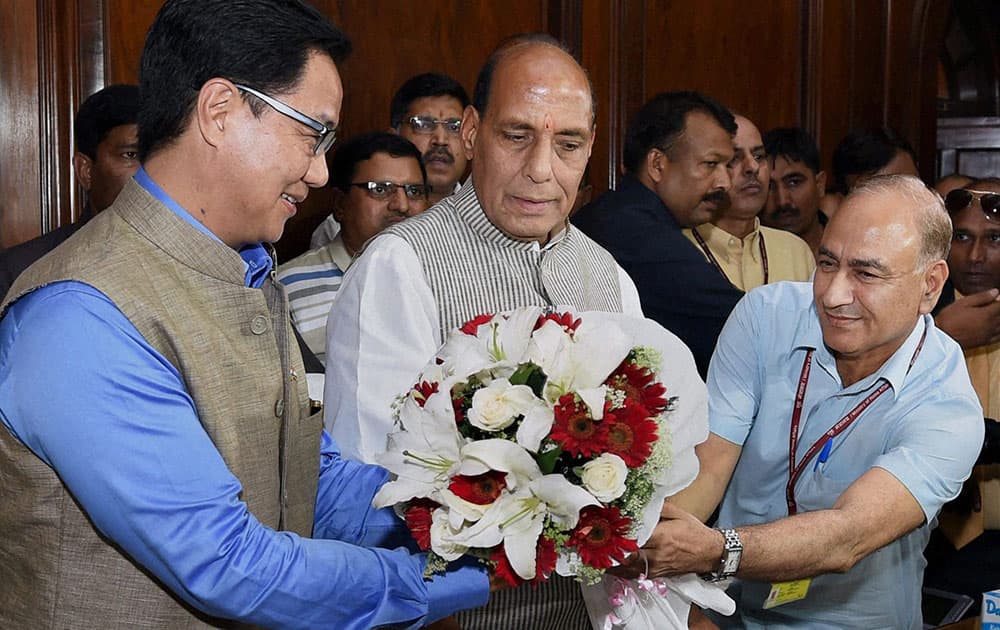Home Minister Rajnath Singh is greeted by MoS Kiren Rijiju and Home Secretary Anil Goswami as he arrives to take charge at his office in New Delhi.