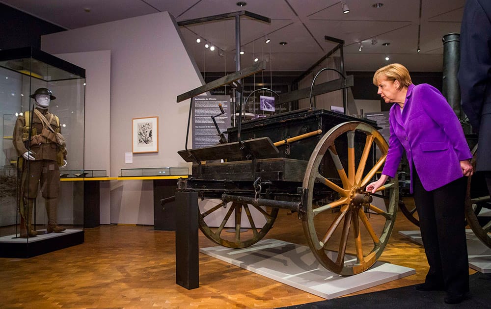 German Chancellor Angela Merkel, looks at a horse drawn field kitchen in a World War I exhibition at the Historical Museum in Berlin.