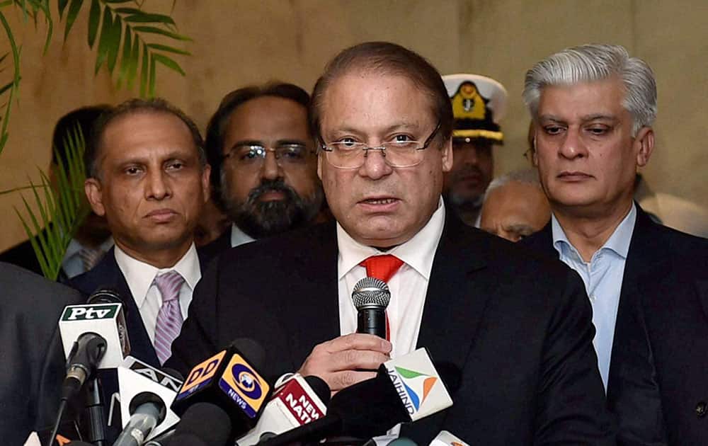Pakistani Prime Minister Nawaz Sharif , center, talks to the media after meeting India`s new prime minister Narendra Modi and before leaving from New Delhi.