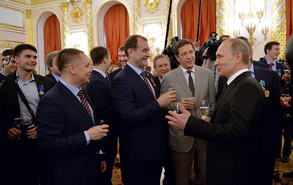 Russian President Vladimir Putin speaks with ice hockey national team players and officials at a ceremony honoring the victory at the Ice Hockey World Championship, in the Kremlin in Moscow.