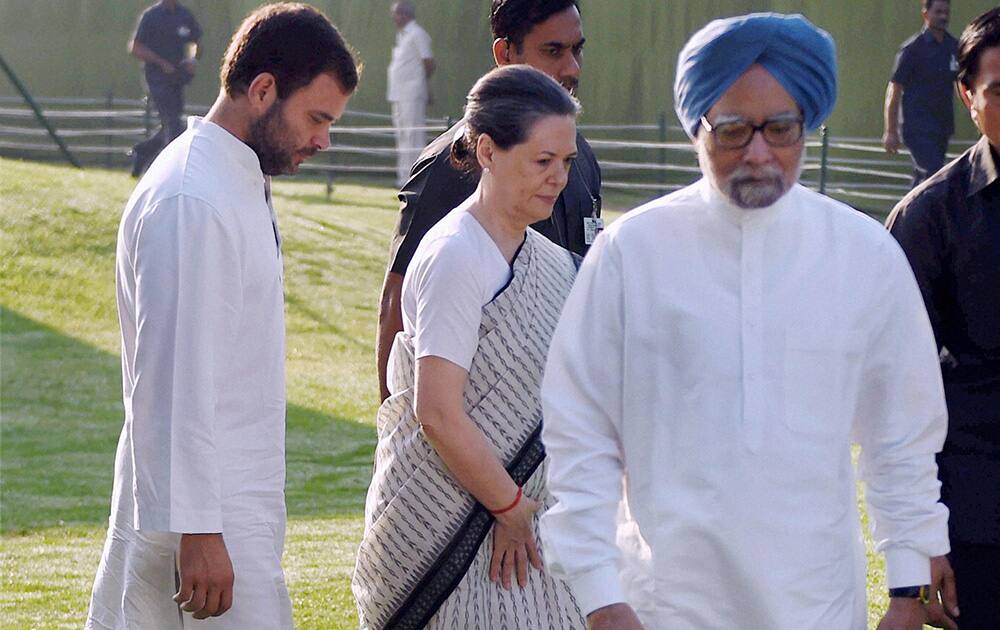 Former Prime Minister Manmohan Singh, Congress President Sonia Gandhi and party`s Vice President Rahul Gandhi after paying tribute to the first Prime Minister the late Pt. Jawahar Lal Nehru on his death anniversary at Shanti Van in New Delhi.