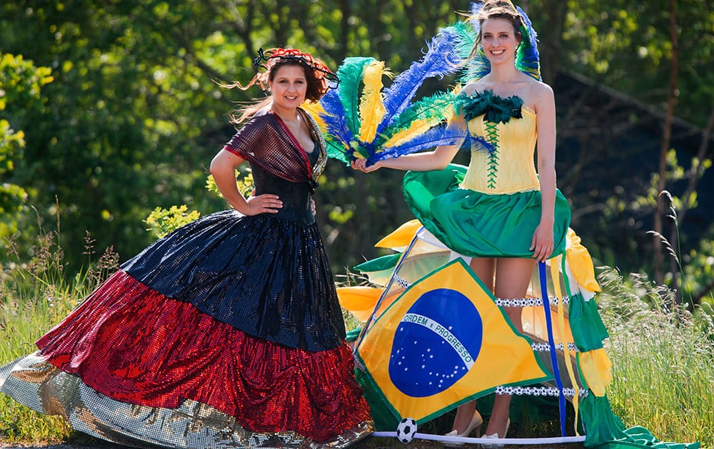 Models Annika Silkeit and Filiz Koc present dresses in Brazilian and German colors created by fashion designer Offenborn on occasion of the upcoming soccer World Cup in Luebeck, Germany.