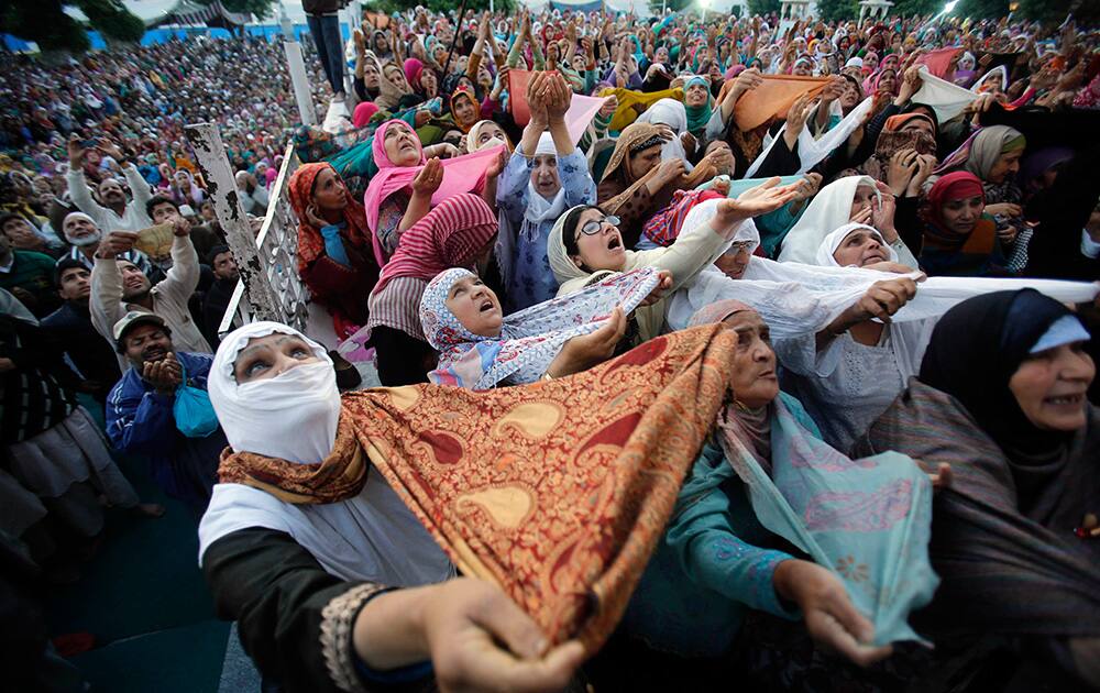 Kashmiri Muslims pray as a head priest, unseen, displays a holy relic believed to be the hair from the beard of Prophet Mohammed, on Mehraj-u-Alam at the Hazratbal Shrine on the outskirts of Srinagar.