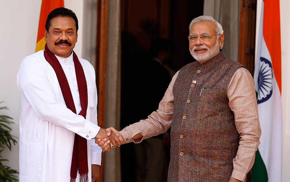 Prime Minister Narendra Modi shakes hand with Sri Lankan President Mahinda Rajapaksa before the start of their meeting in New Delhi.