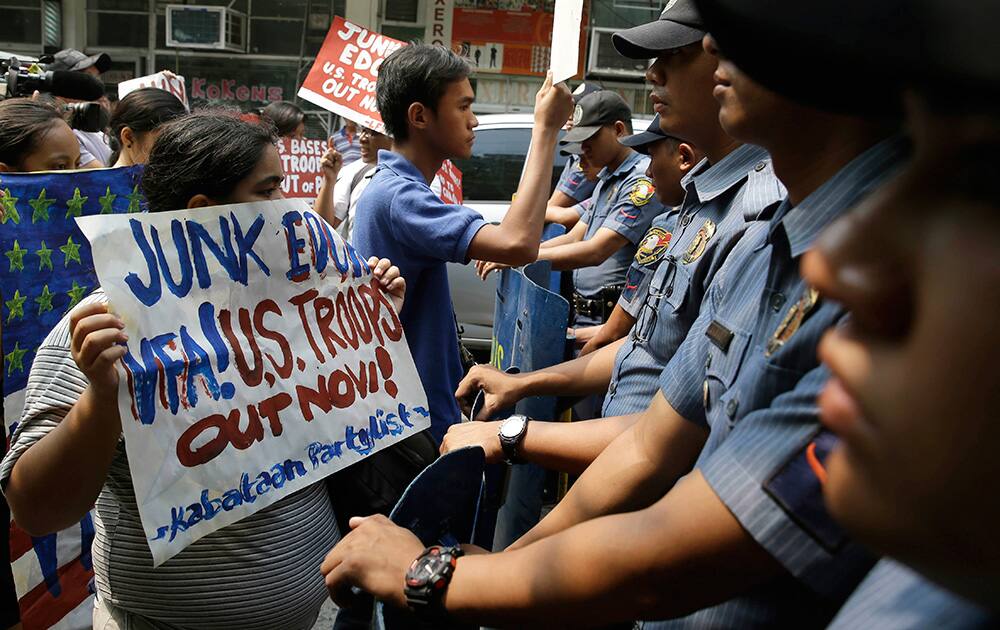 Protesters are blocked by police as they attempt to hold a rally closer to the U.S. Embassy in Manila, Philippines to protest the recent agreement between the Philippine and U.S. militaries known as the Enhanced Defense Cooperation Agreement (EDCA).