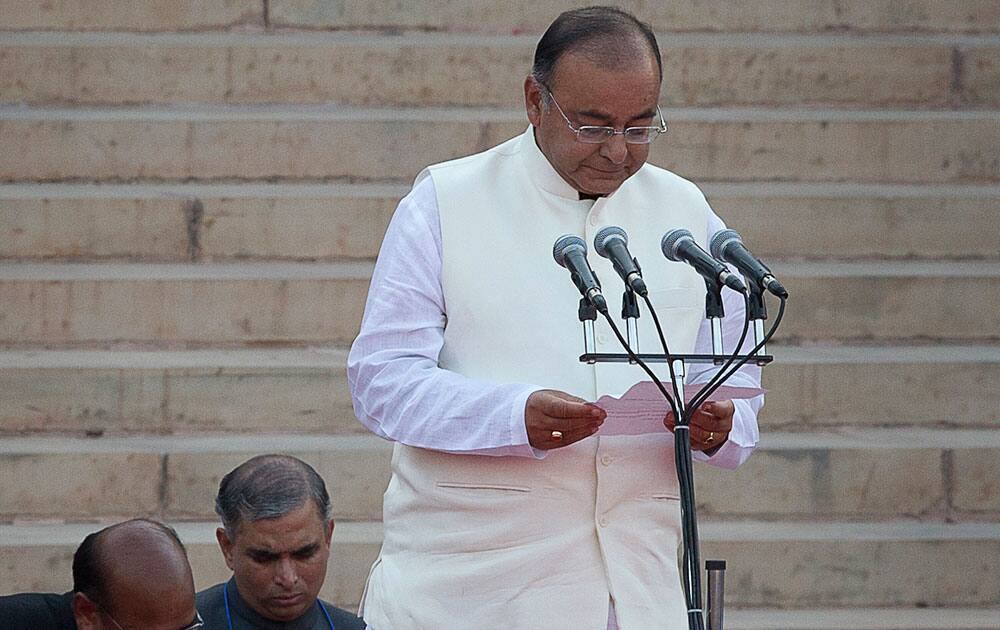 Indian Cabinet Minister Arun Jaitley takes the oath of office at the presidential palace in New Delhi.