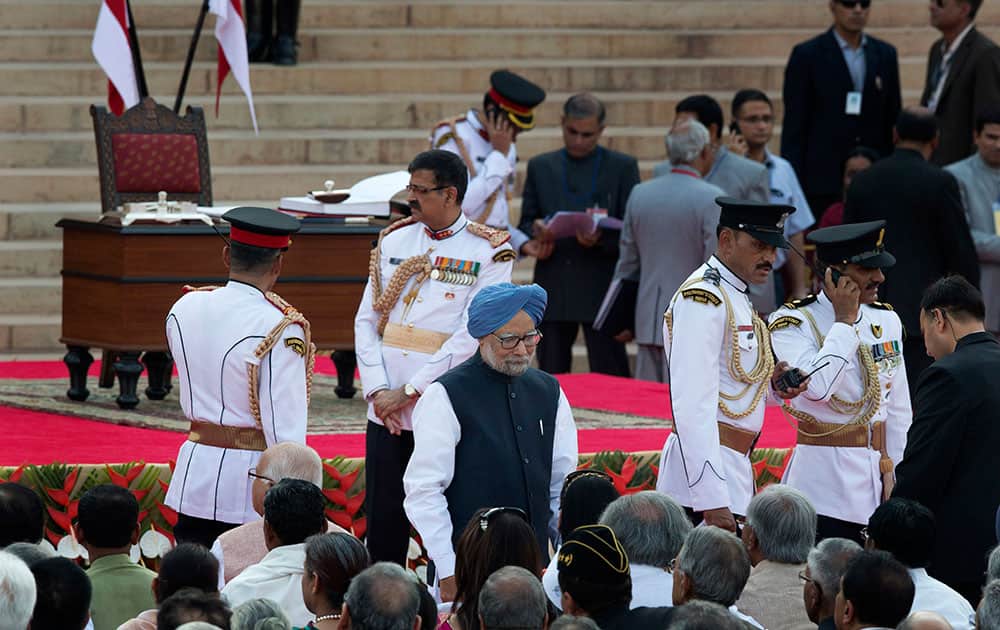 India’s outgoing prime minister Manmohan Singh, center in blue turban, arrives for the swearing in ceremony of new prime minister Narendra Modi, in New Delhi.