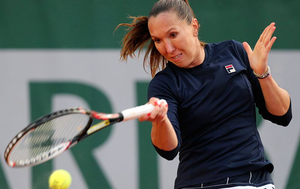 Serbia`s Jelena Jankovic returns the ball to Canada`s Sharon Fichman during the first round match of the French Open tennis tournament at the Roland Garros stadium, in Paris.