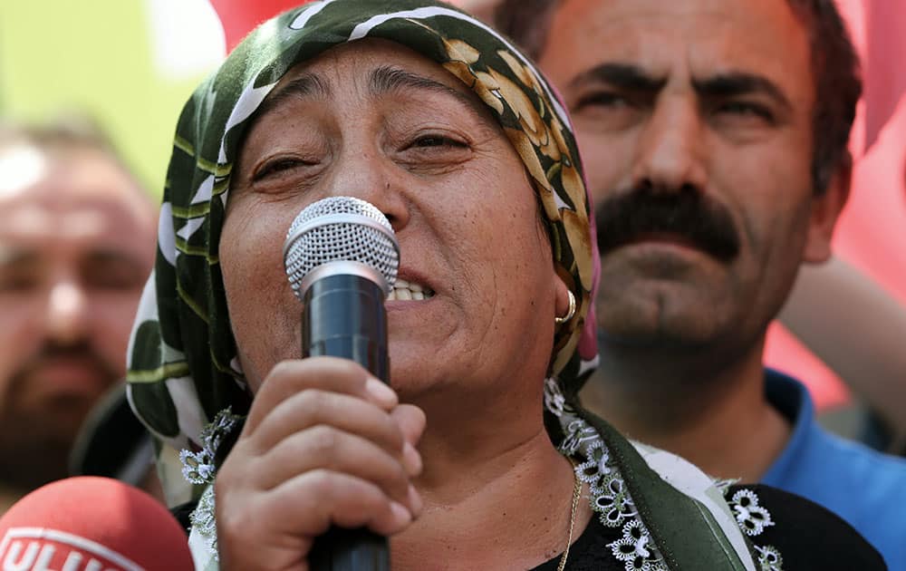 Safi Sarisuluk speaks to people gathered outside a courthouse, where a police officer stands on trial, accused of killing her son Ethem Sarisuluk, during anti-government protests last June, in Ankara, Turkey.