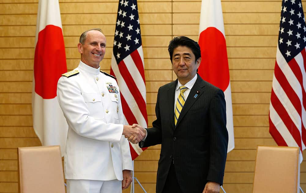 U.S. Chief of Naval Operations Adm. Jonathan Greenert, left, poses with Japanese Prime Minister Shinzo Abe for photographers before the start of their meeting at Abe`s official residence in Tokyo.