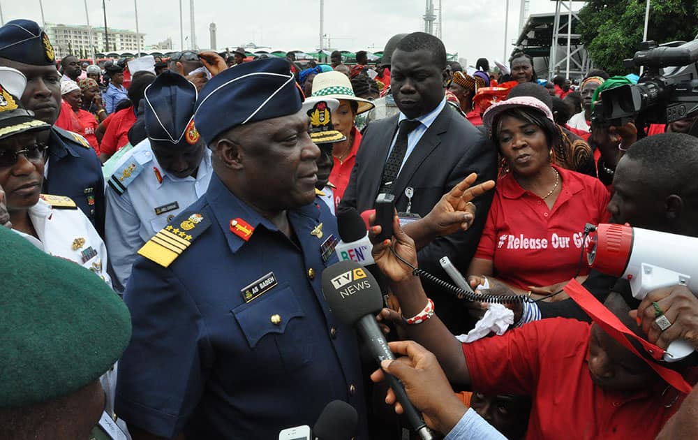 Nigeria`s chief of defense staff Air Marshal Alex S. Badeh, centre, speaks during a demonstration calling on the government to rescue the kidnapped girls of the government secondary school in Chibok, in Abuja, Nigeria.