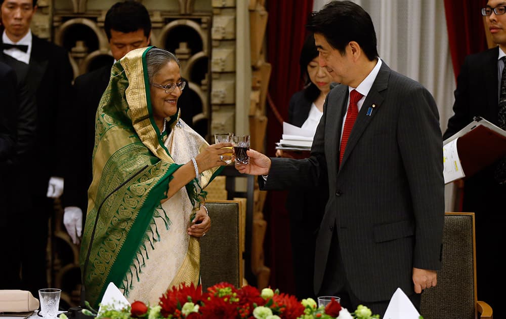 Bangladesh`s Prime Minister Sheikh Hasina toasts with Japan`s Prime Minister Shinzo Abe during a banquet hosted by Abe at Abe`s residence in Tokyo.