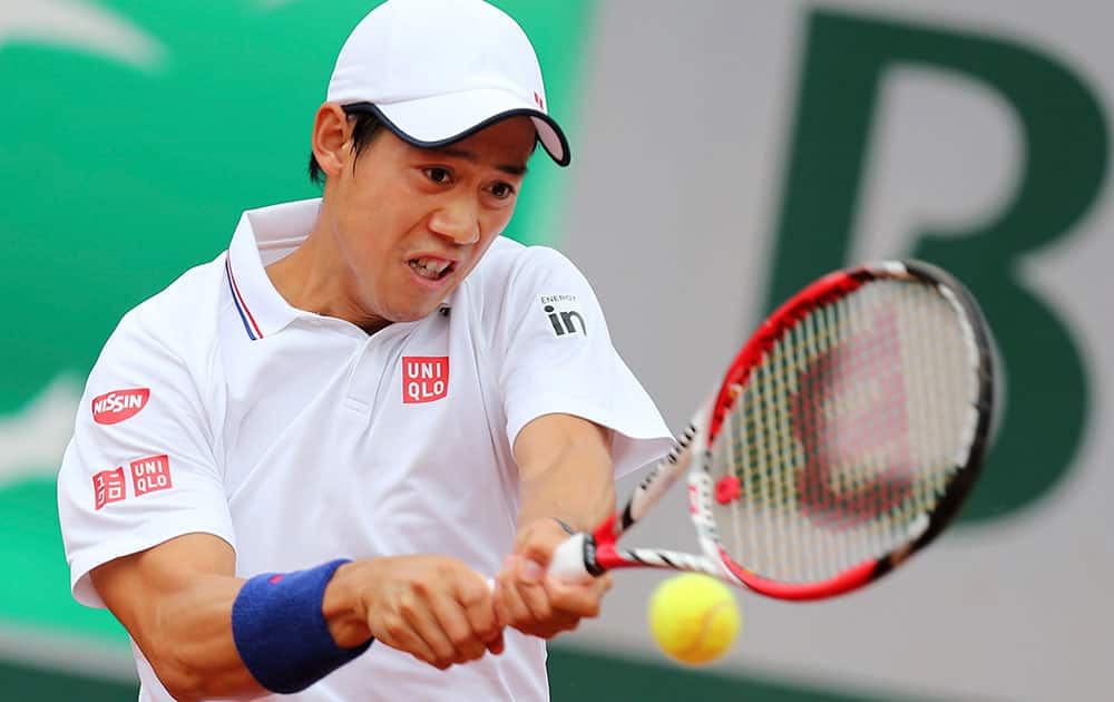 Japan`s Kei Nishikori returns the ball during the first round match of the French Open tennis tournament against Slovakia`s Martin Klizan at the Roland Garros stadium, in Paris.