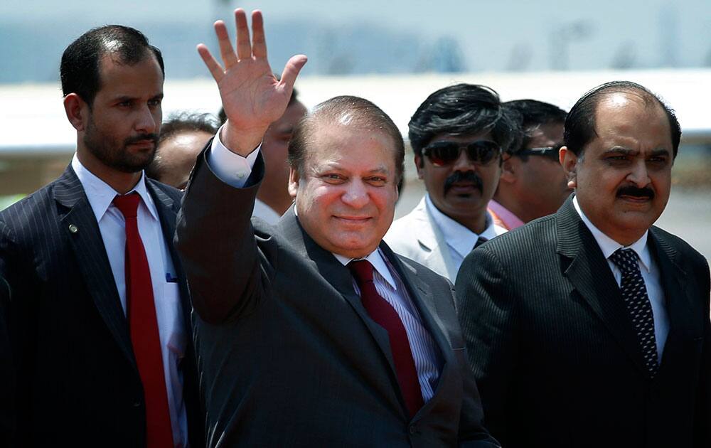 Pakistani Prime Minister Nawaz Sharif waves as he arrives to attend the swearing in ceremony of India’s prime minister elect Narendra Modi in New Delhi.