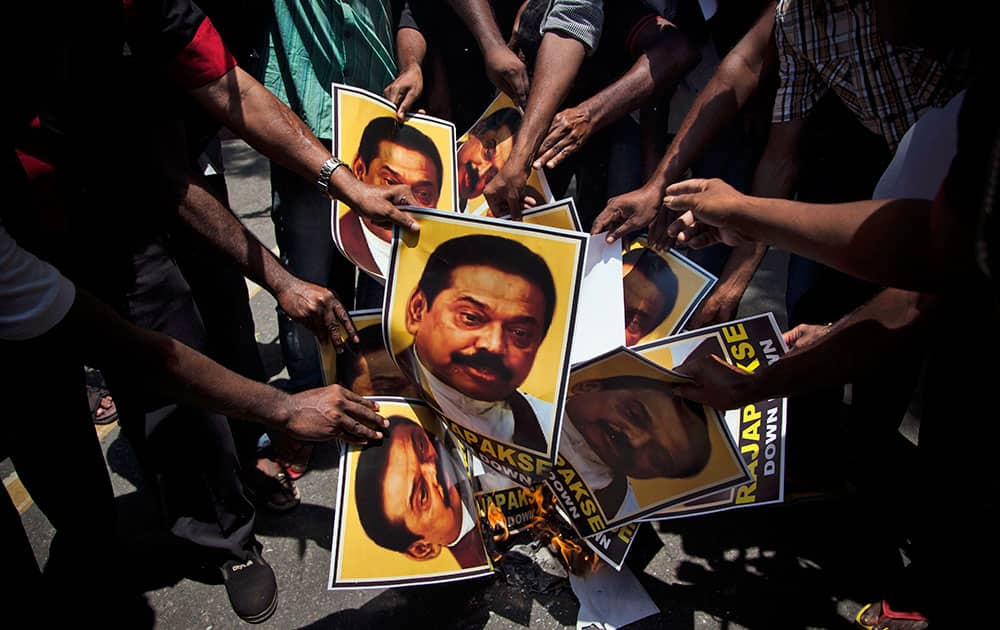 Supporters of Marumalarchi Dravida Munnetra Kazhagam (MDMK) burn portraits of Sri Lankan President Mahinda Rajapaksa during a protest in New Delhi.