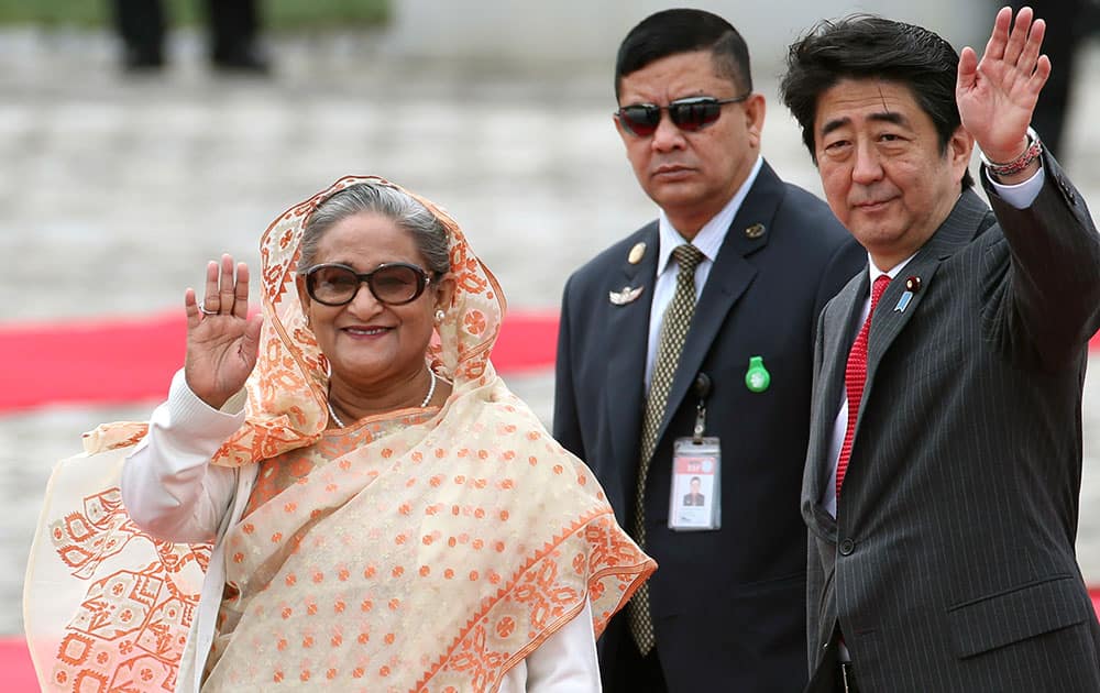 Bangladesh`s Prime Minister Sheikh Hasina waves during a welcome ceremony with Japanese Prime Minister Shinzo Abe, right , at Akasaka State Guest House in Tokyo.
