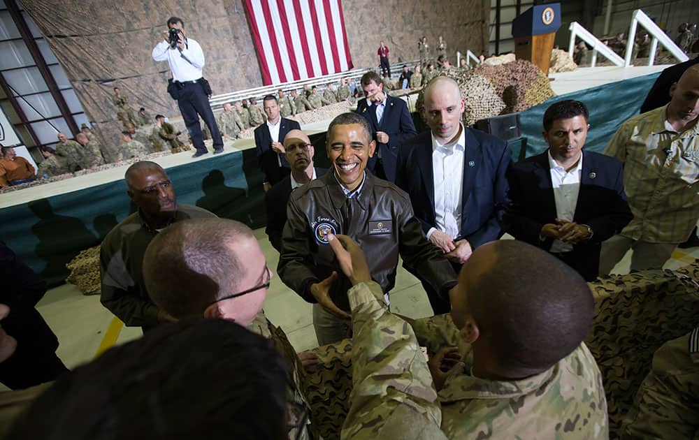 President Barack Obama shakes hands at a troop rally at Bagram Air Field, north of Kabul, Afghanistan, during an unannounced visit.