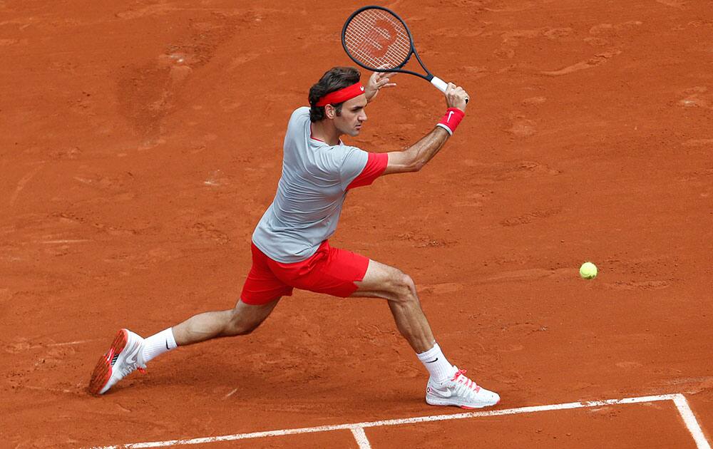 Switzerland`s Roger Federer returns the ball during the first round match of the French Open tennis tournament against Slovakia`s Lukas Lacko at the Roland Garros stadium, in Paris.